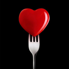 Red heart close up on a black background.