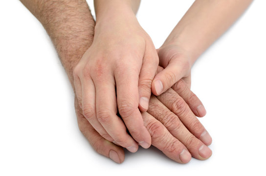 Hands of young woman hold hands of an old man