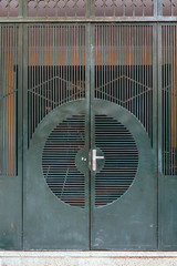 Dark green steel door with line and circle form in Hanoi, Vietnam.  
