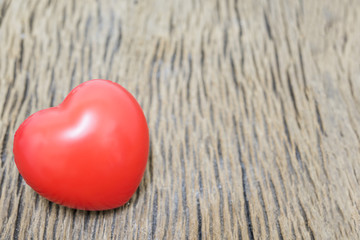 Fototapeta premium Red heart on the wooden background for copy space.