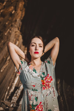 Young model in floral dress in sunlight