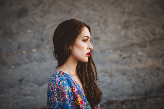 Model standing against rocky terrain