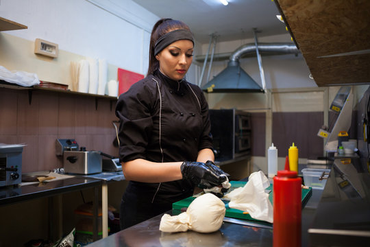 a girl prepares sushi on kitchen