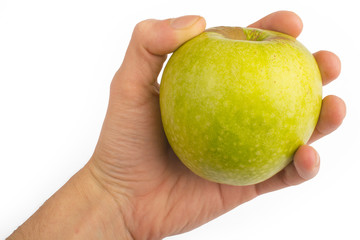 in a hand a green apple isolated on a white background