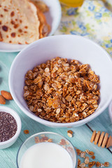 breakfast with home made granola and pancakes on turquoise surface