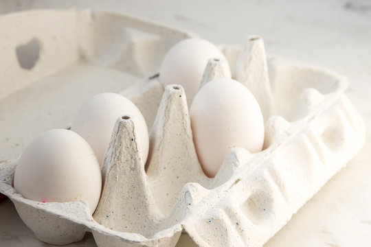 Eggs in a special box. Four white eggs