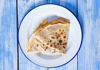 crepe on blue wooden surface