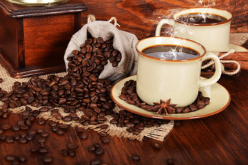 a linen bag full of coffee beans with a cup of freshly brewed black coffee
