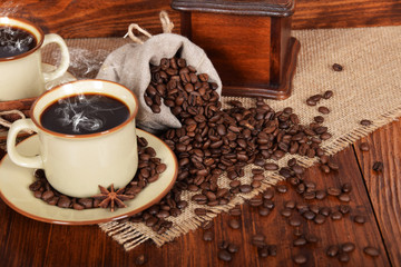 a linen bag full of coffee beans with a cup of freshly brewed black coffee with free space for text