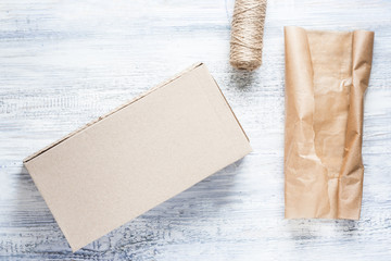 boxes of gifts with natural paper and floss on a white wooden table. top view, place for your text...