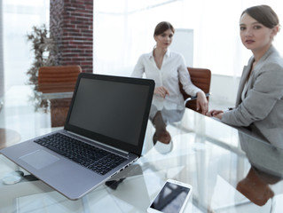 laptop and a smartphone on the desktop of a businessman