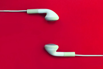 white headphones  on a red background.