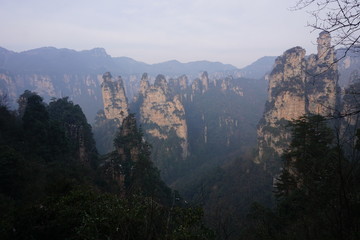 Fototapeta premium Mountains in China with trees and dust in sunshine