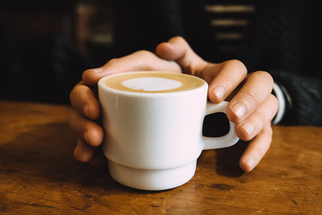 Girl holding a hot cup of coffee
