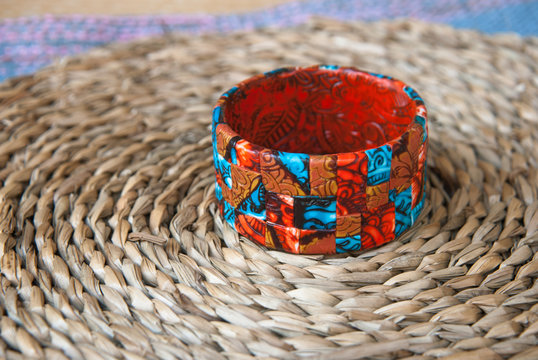 Ethnic jewellery bracelet on Blue fabric. Handmade jewelry bracelet of polymer clay.Fashion background with bagle bracelet.Hobby, handicraft.