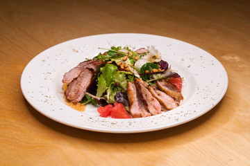 Restaurant dish meat salad from pork and arugula