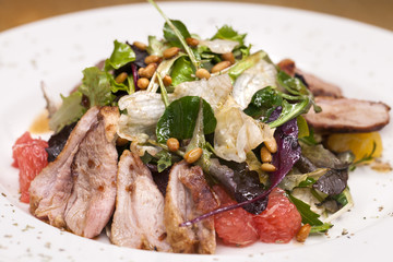 Restaurant dish meat salad from pork and arugula
