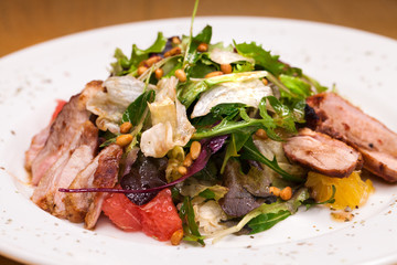 Restaurant dish meat salad from pork and arugula