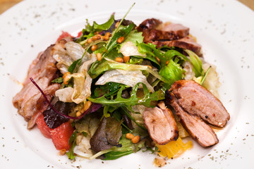 Restaurant dish meat salad from pork and arugula