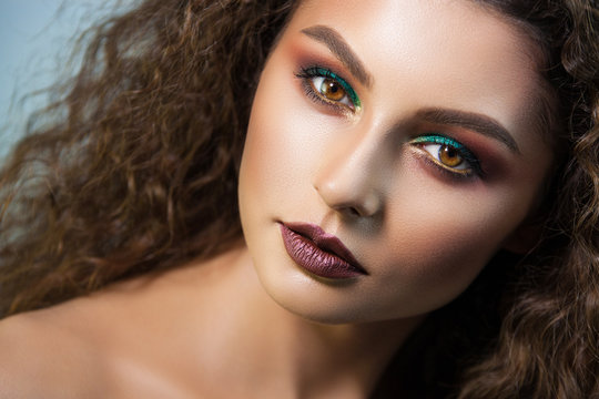beautiful curly girl and green shadows under the eyes image created by professional make-up artist