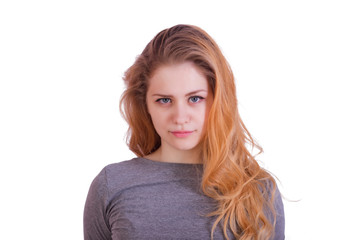 Naklejka premium Portrait of a charming red-haired long-haired girl looking directly into the camera