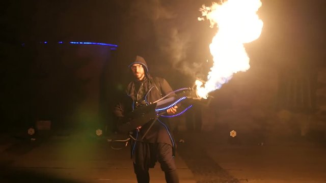 Artist with a flamethrower in his hand during a performance. Fireshow.