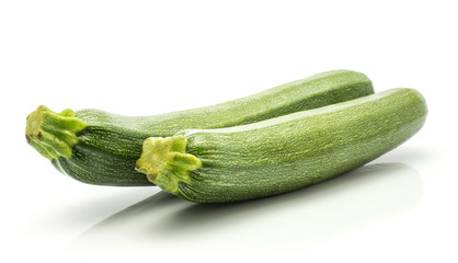 Green zucchini isolated on white background two long raw courgettes.