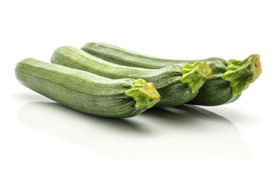 Three green zucchini long raw courgettes in row isolated on white background.