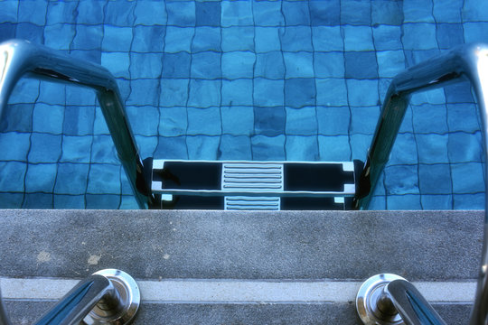 Pool ladder in swimming pool .