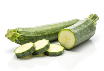 One green zucchini one half three round slices isolated on white background long raw courgette.
