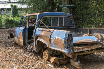rusted car wreck in a Hill Tribe Village