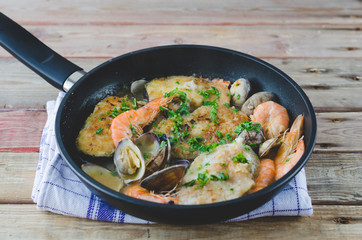 Hake slices cooked with prawns and clams.