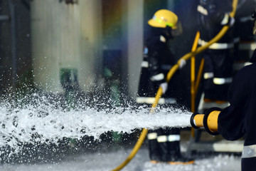 Firemen ,Fireman in action activated foam . ,Background for emergency  response .