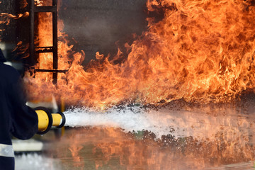 Firemen ,Fireman in action activated foam . ,Background for emergency  response .