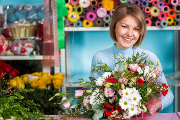 Florist in the workplace. Flower shop. Portrait of a smiling beautiful woman