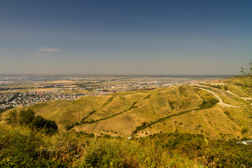 Fototapeta na wymiar View over city outskirts to flat plain.