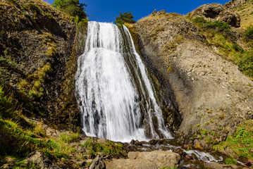 Artsci waterfall - a beautiful waterfall and natural landmark near Stepantsminda (Kazbegi) village, Caucasus mountains, Georgia