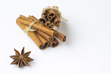 Spices: star anise and cinnamon sticks on white background. Close up. Top view.