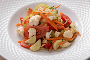 salad with fresh vegetables carrot pepper tomato cauliflower onion greens