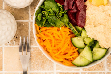 Vegan or Vegetarian Salad Food Bowl With Beetroot Hummus Carrots Cucumber And Watercress