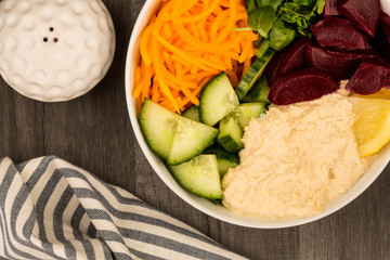 Vegan or Vegetarian Salad Food Bowl With Beetroot Hummus Carrots Cucumber And Watercress
