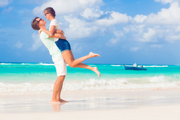 happy young couple having fun by the beach