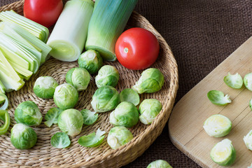 Brussels sprouts (Brassica oleracea) tomato, leek in a basket