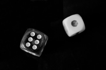 Two dice, on a black background.  The figures are one and six.