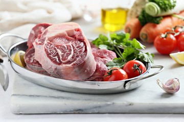 Beef cut with fresh vegetables. Raw meat ready to cook with seasonal vegetables. Osso bucco ingredients. Selective focus