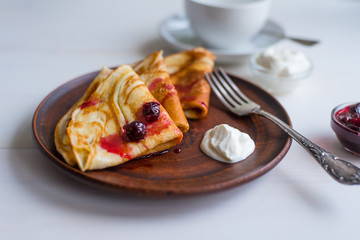 Village pancakes with jam on a rustic tray for breakfast