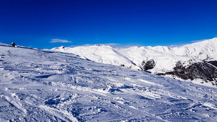 Winter holiday in the Alps mountains under blue sky