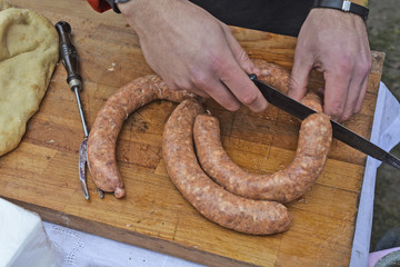 Cook prepares for baking freshly sausage