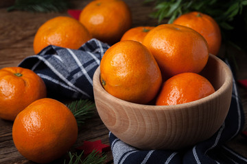 Fresh oranges in wooden bowl.