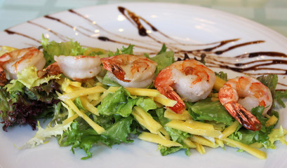 appetizing prawns with greens and cheese close-up